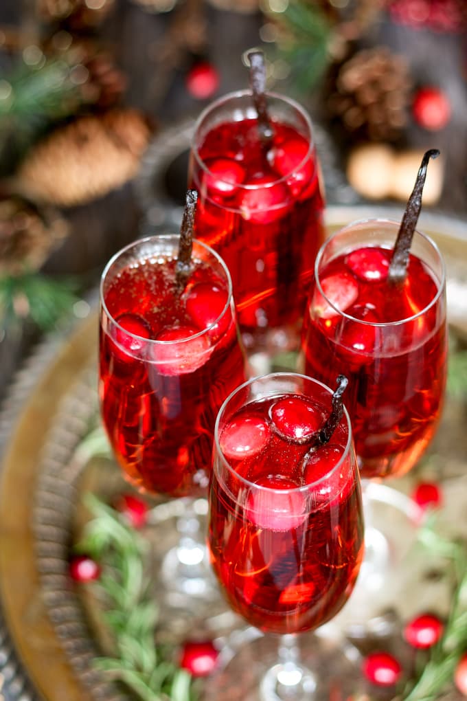 This vanilla cranberry mimosa cocktail is perfect for winter brunches, Christmas, and holiday and New Year's Eve parties! This drink recipe only requires 3 ingredients and is very easy to make. | honeyandbirch.com