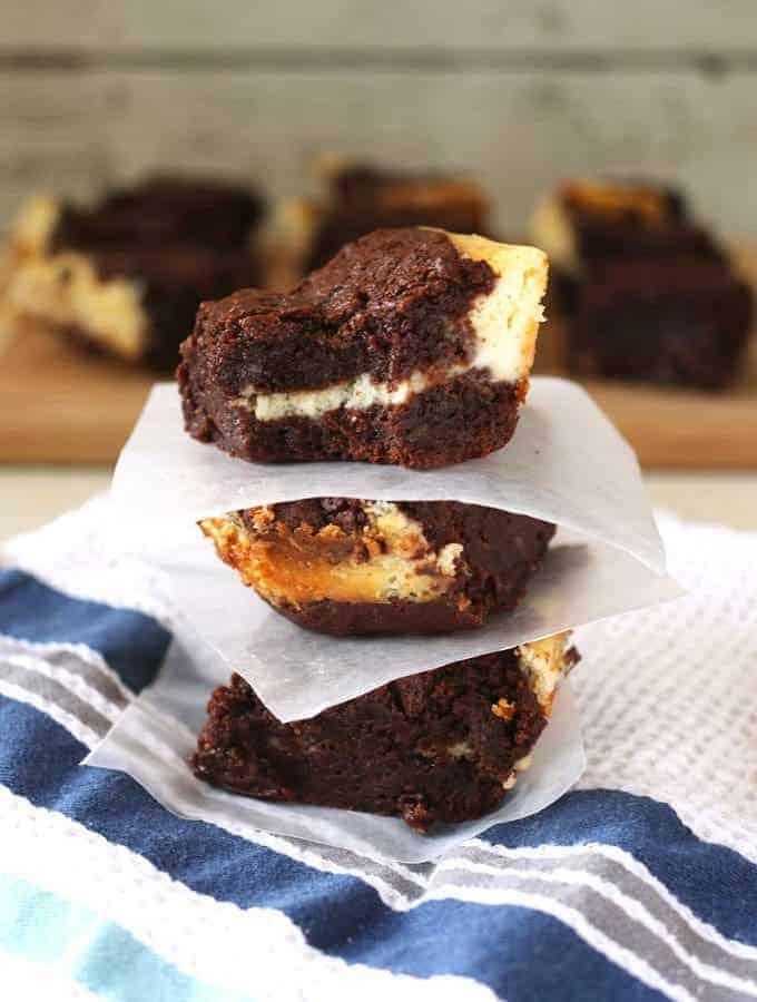 These cream cheese fudge brownies are decadently delicious! A smooth cream cheese layer is sandwiched between two layers of chocolate fudge. | honeyandbirch.com