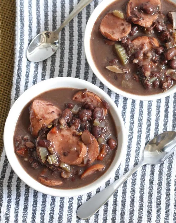 A delicious and easy recipe for slow cooker black bean turkey sausage stew. It requires very little prep but packs a lot of flavor into every bite! | honeyandbirch.com