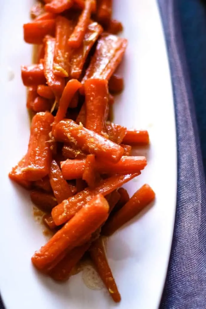 white plate with ginger candied carrots