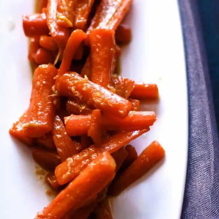 white plate with ginger candied carrots