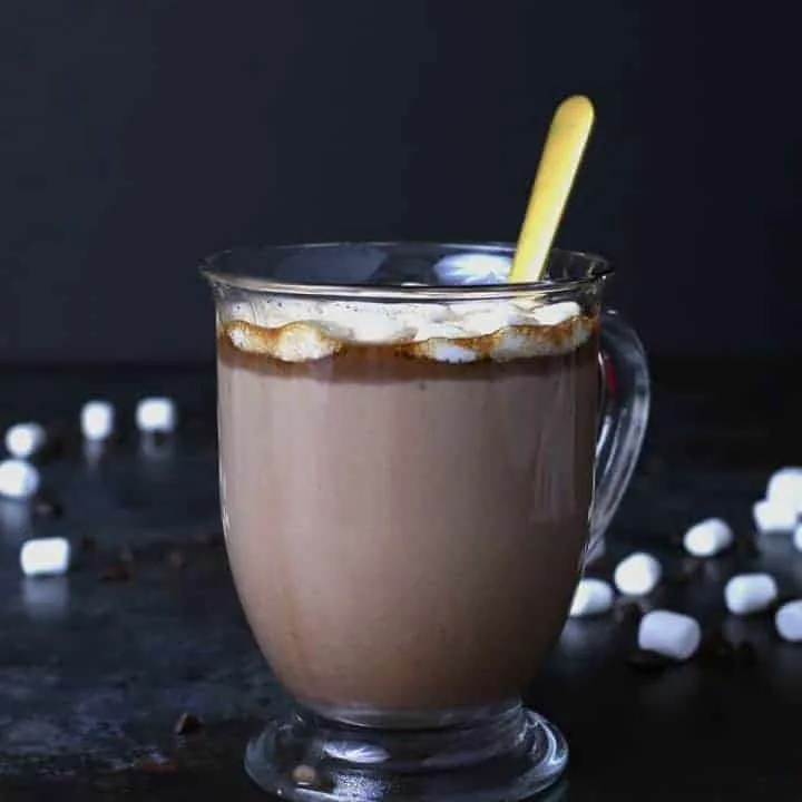 Slow cooker Kahlua hot cocoa warms you up in more ways than one! Add some marshmallows to this hot chocolate and you're all set for chilly winter nights or holiday parties! This is going to become your favorite winter cocktail / dessert combination! | honeyandbirch.com