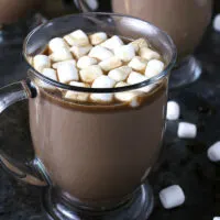 Slow cooker Kahlua hot cocoa warms you up in more ways than one! Add some marshmallows to this hot chocolate and you're all set for chilly winter nights or holiday parties! This is going to become your favorite winter cocktail / dessert combination! | honeyandbirch.com