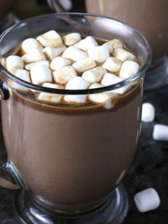 Slow cooker Kahlua hot cocoa warms you up in more ways than one! Add some marshmallows to this hot chocolate and you're all set for chilly winter nights or holiday parties! This is going to become your favorite winter cocktail / dessert combination! | honeyandbirch.com