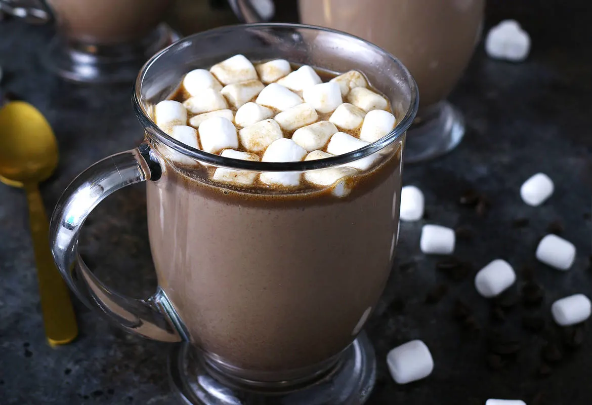 Slow cooker Kahlua hot cocoa warms you up in more ways than one! Add some marshmallows to this hot chocolate and you're all set for chilly winter nights or holiday parties! This is going to become your favorite winter cocktail / dessert combination! | honeyandbirch.com
