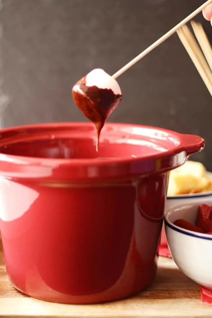marshmallow dipped into chocolate fondue