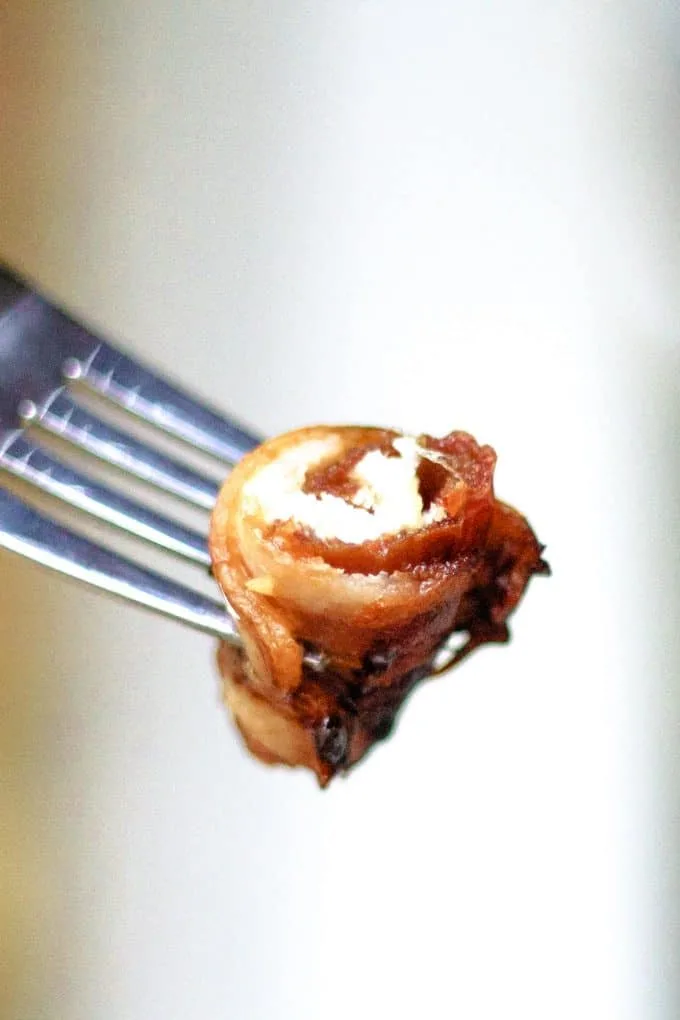 bacon wrapped date on a fork