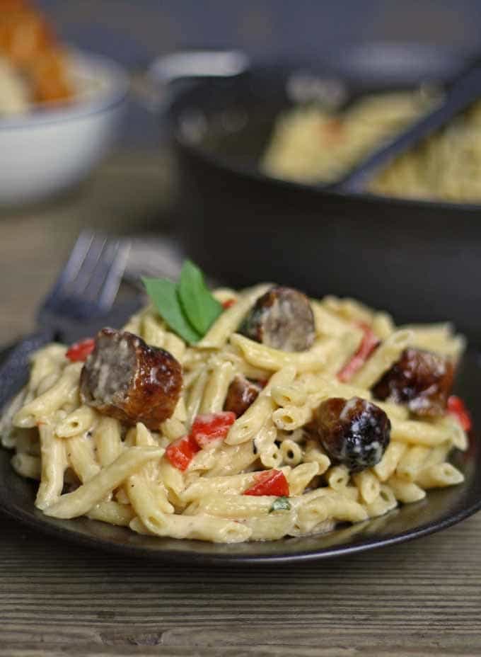 This brown butter alfredo pasta with roasted red peppers and sausage is perfect for Sunday dinner and a great way to use up leftover grilled sausage. | honeyandbirch.com