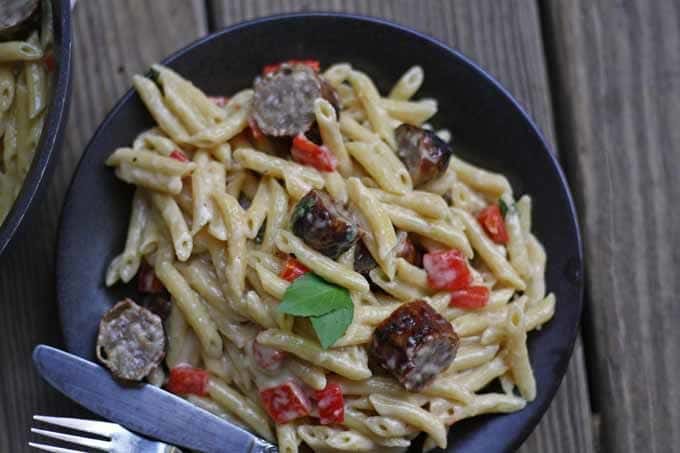 This brown butter alfredo pasta with roasted red peppers and sausage is perfect for Sunday dinner and a great way to use up leftover grilled sausage. | honeyandbirch.com