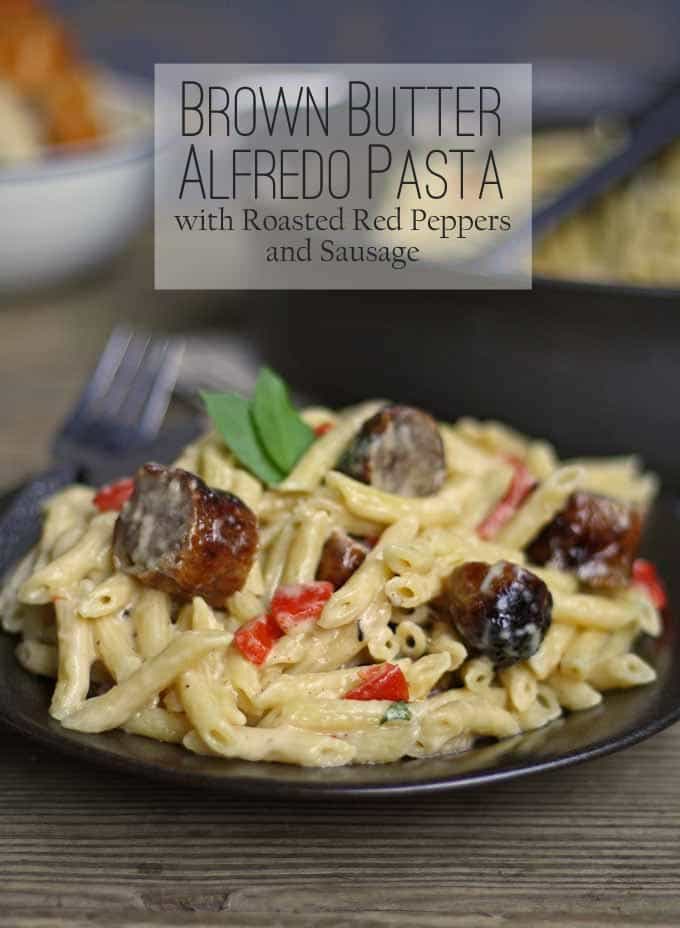 This brown butter alfredo pasta with roasted red peppers and sausage is perfect for Sunday dinner and a great way to use up leftover grilled sausage. | honeyandbirch.com