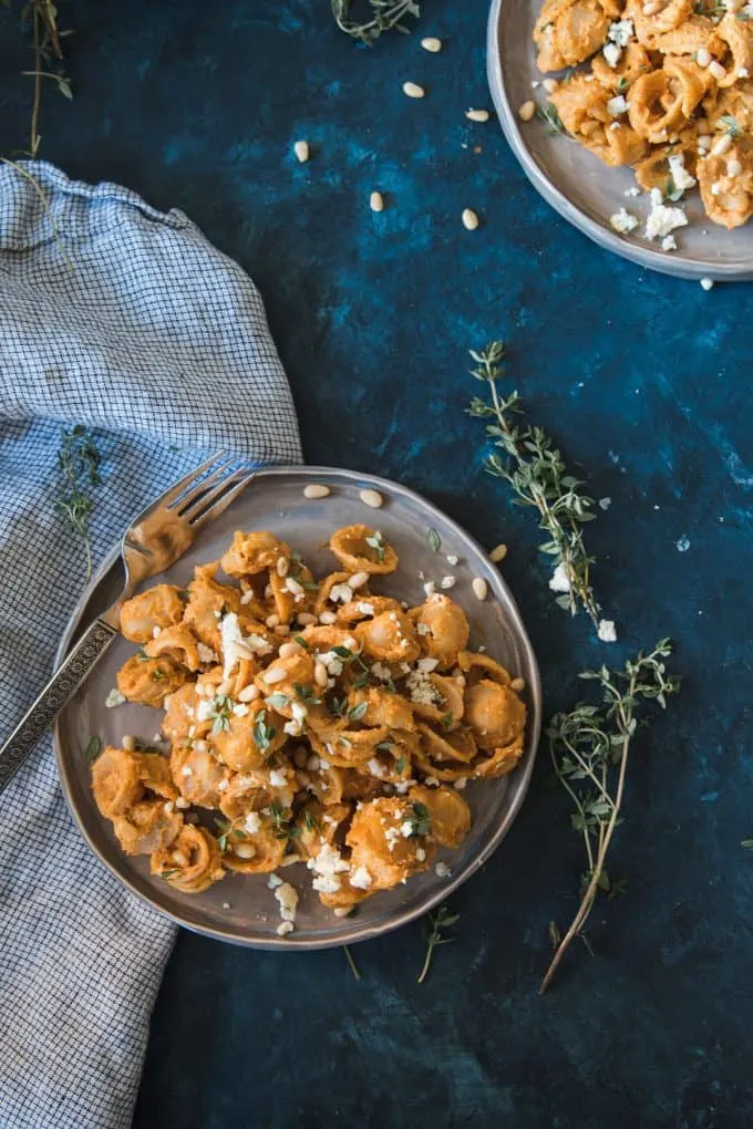 one plate of pasta with pumpkin sauce on a blue board