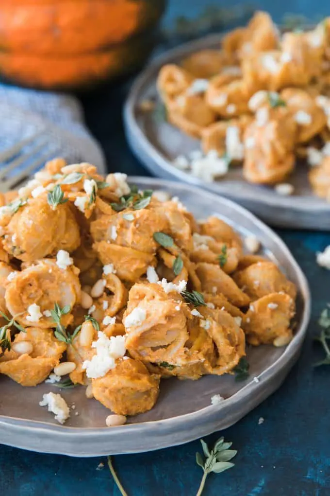 two plates of pasta with pumpkin sauce