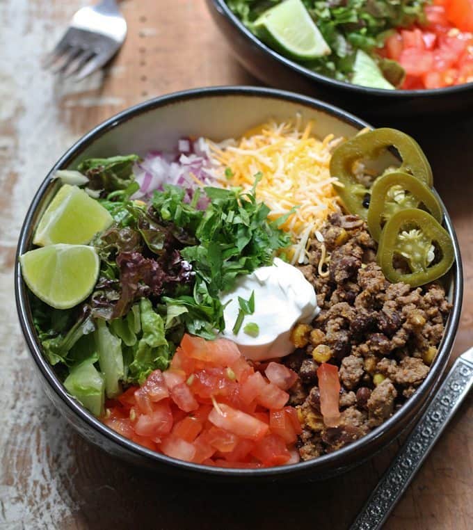 This recipe for loaded burrito bowls will hit the spot if you have picky eaters or need to eat dinner quick. Load the table with a variety of burrito fillings to make this everyone's favorite! | www.honeyandbirch.com
