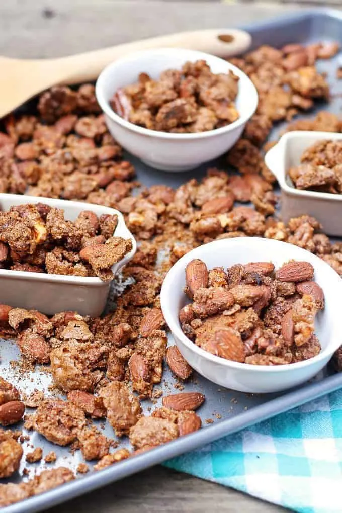 pumpkin pie spiced nuts on a metal tray in bowls