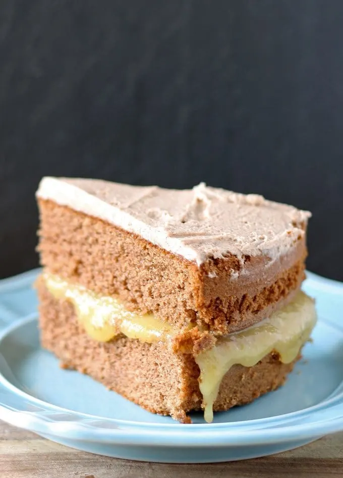 This spice cake has an apple curd filling and is topped with cinnamon marscapone frosting. It is perfect for fall and Thanksgiving! | www.honeyandbirch.com