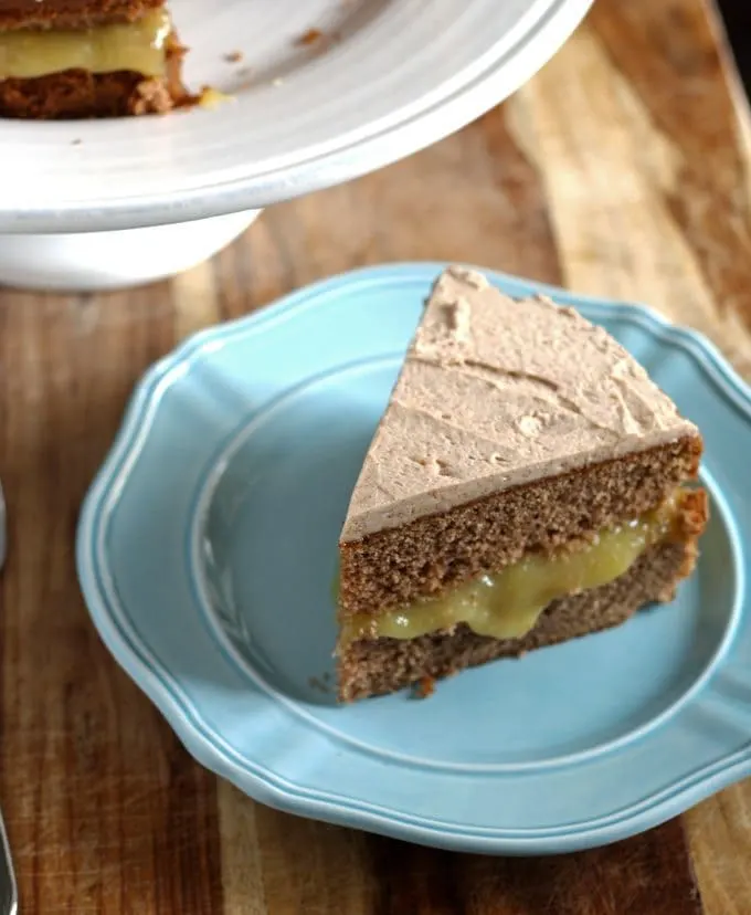 This spice cake has an apple curd filling and is topped with cinnamon marscapone frosting. It is perfect for fall and Thanksgiving! | www.honeyandbirch.com