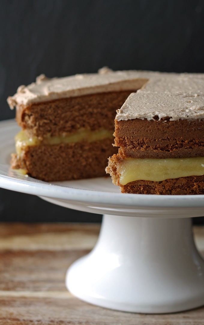 This spice cake has an apple curd filling and is topped with cinnamon marscapone frosting. It is perfect for fall and Thanksgiving! | www.honeyandbirch.com