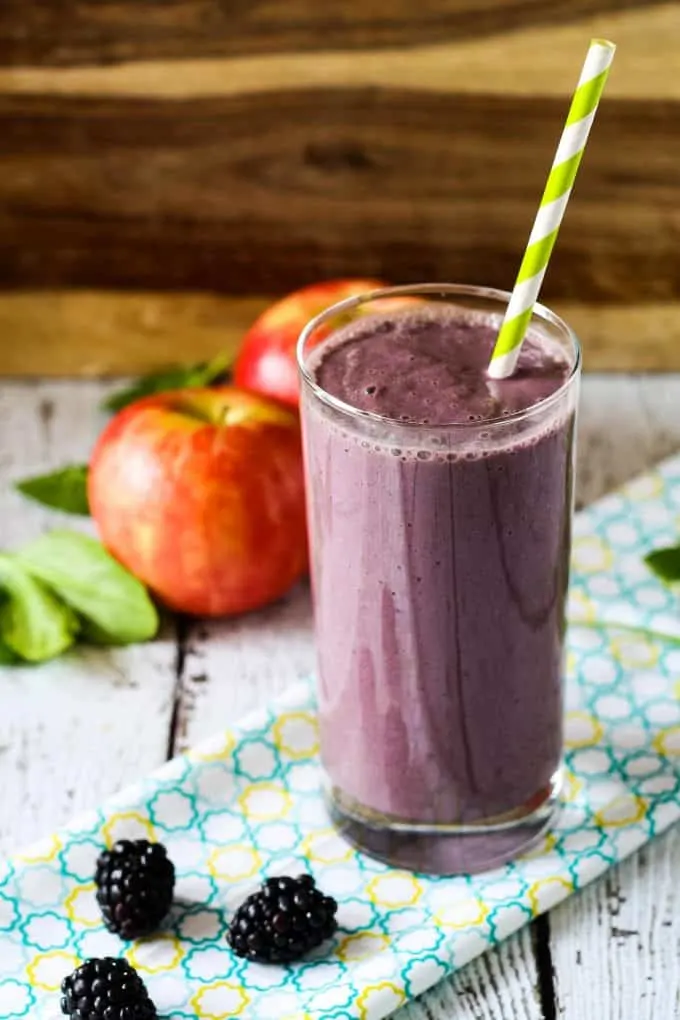 blackberry apple smoothie with a green straw