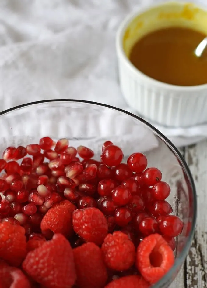 Red Fruit Salad | Sweet and tart, full of raspberries, pomegranate and red currant! www.honeyandbirch.com #fruit #salad