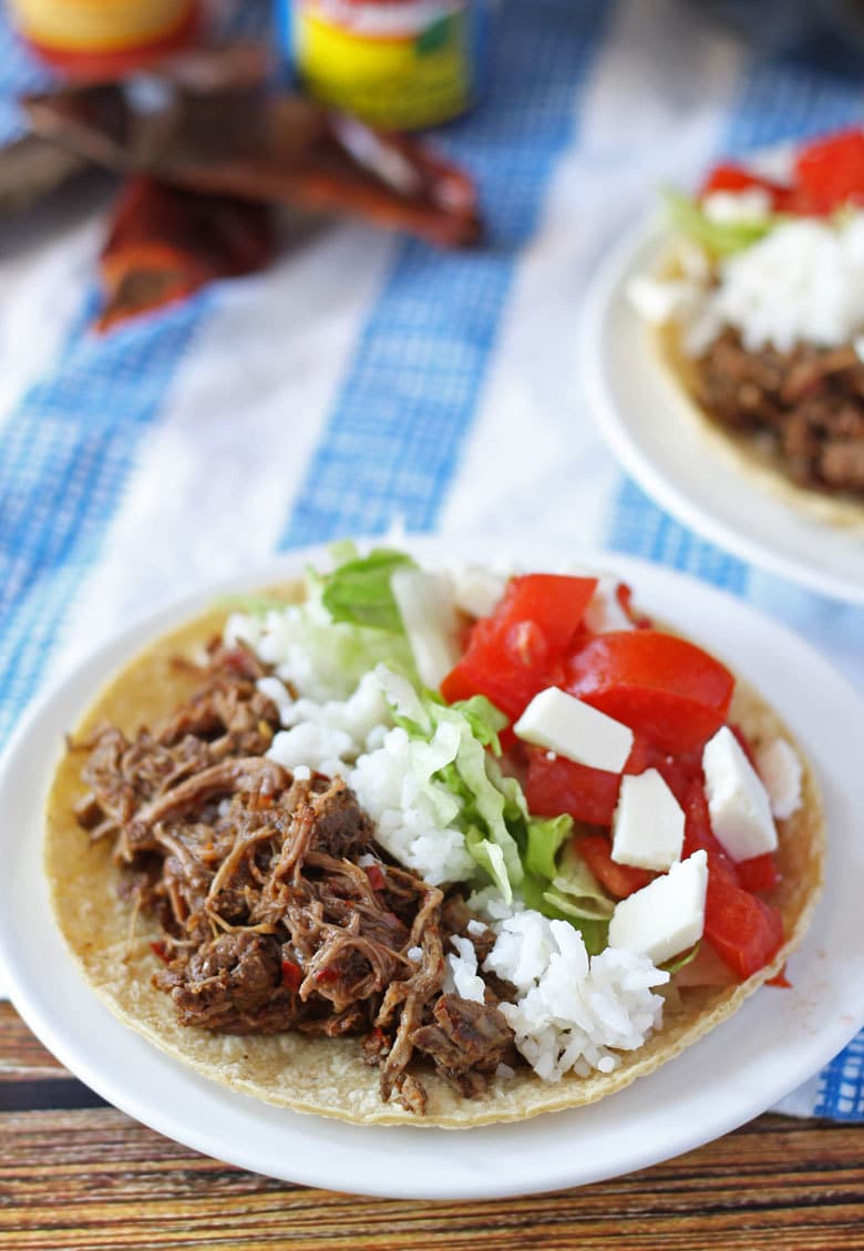 slow cooker barbacoa beef in a taco