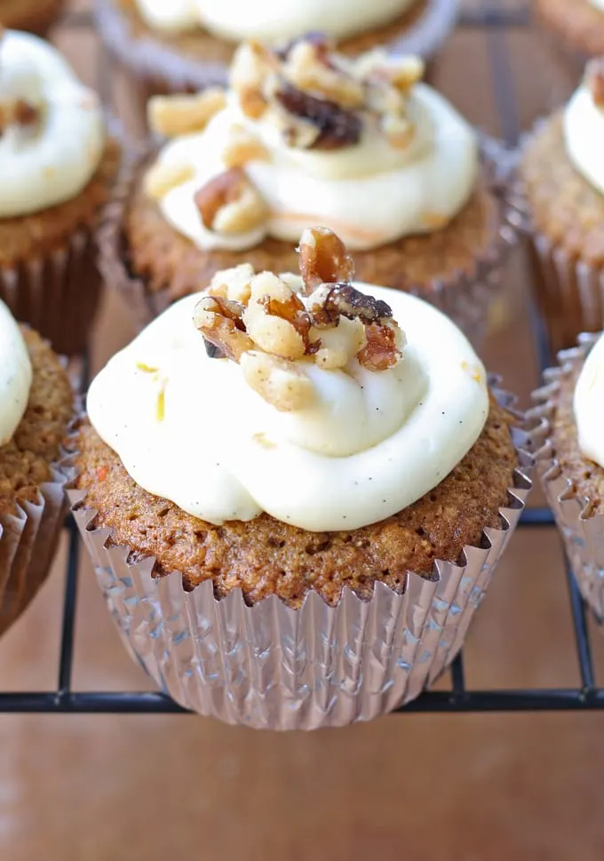 Delicious carrot cake cupcakes, filled and topped with sweet cream cheese frosting! | honeyandbirch.com