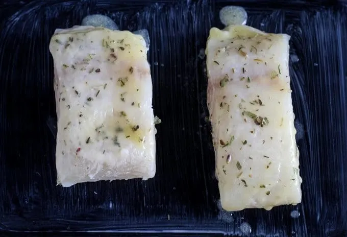 cooked halibut in a glass baking dish