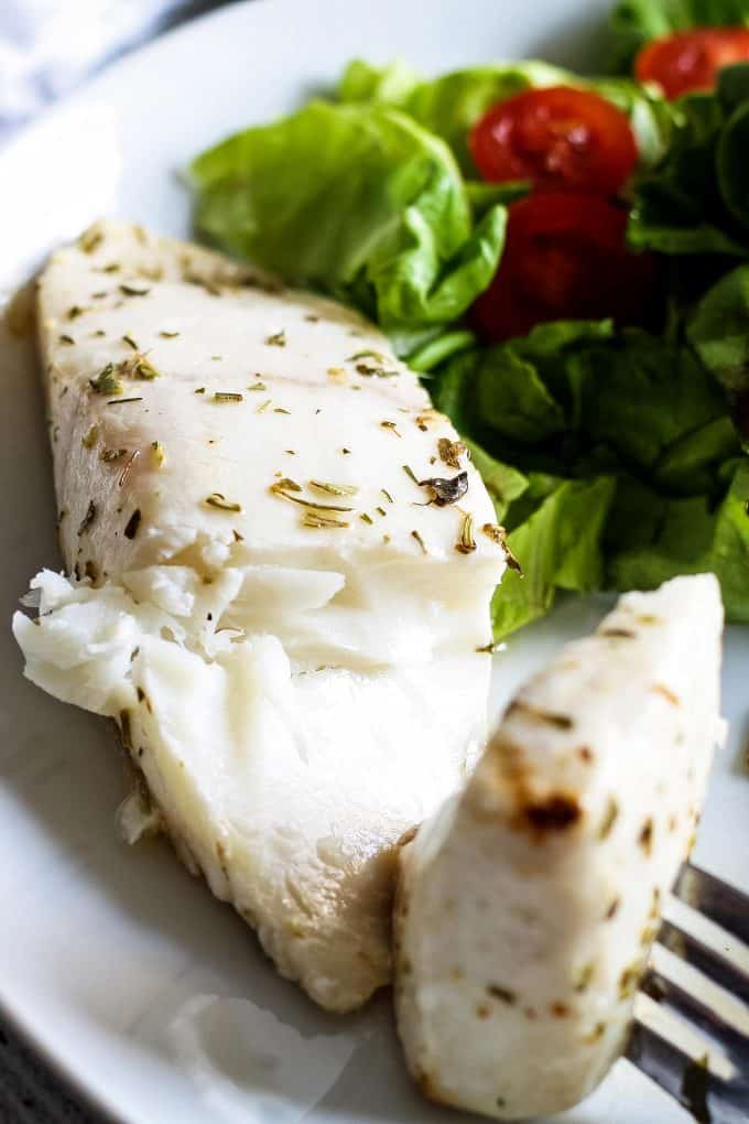 cooked alaskan halibut on a fork