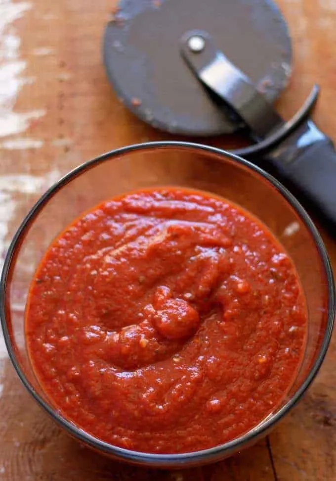 homemade pizza sauce and a pizza cutter
