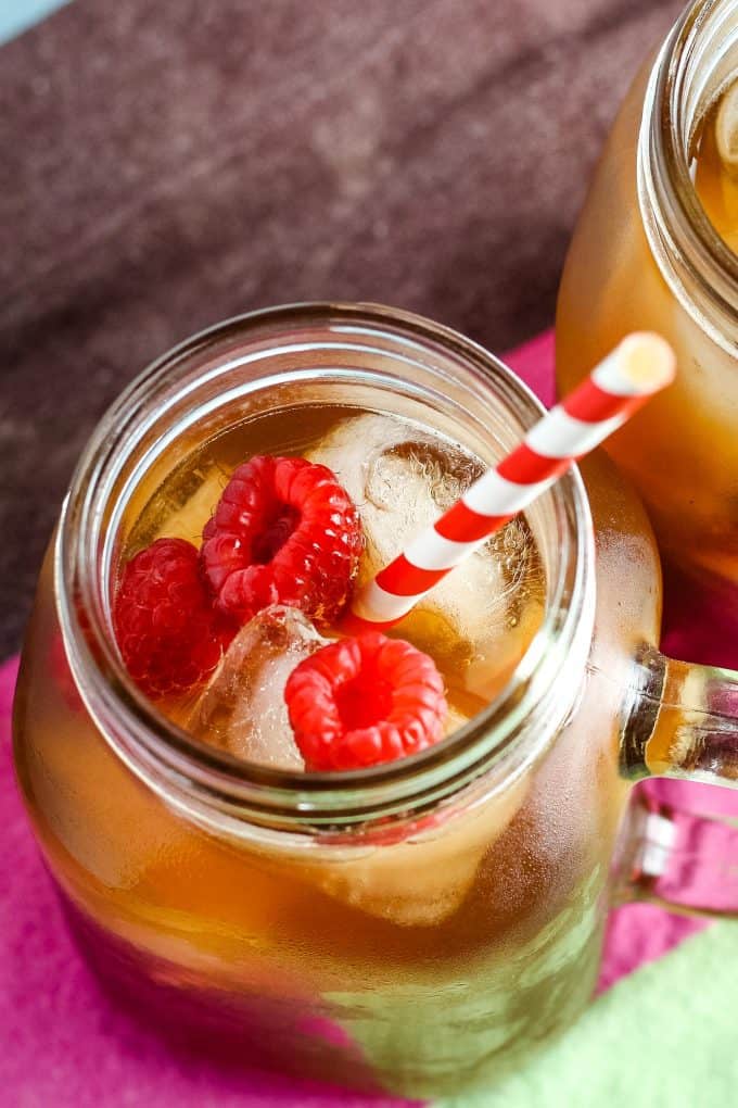 overhead photo of mug with raspberry sweet tea cocktail