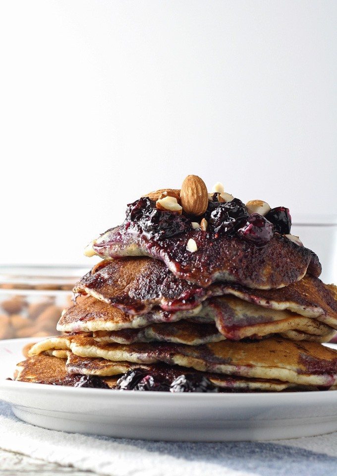 Start your day with these delicious blueberry almond pancakes, topped with homemade honey poached blueberries. Perfect for breakfast!  honeyandbirch.com