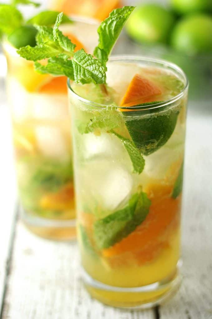 two orange mojitos in clear glasses