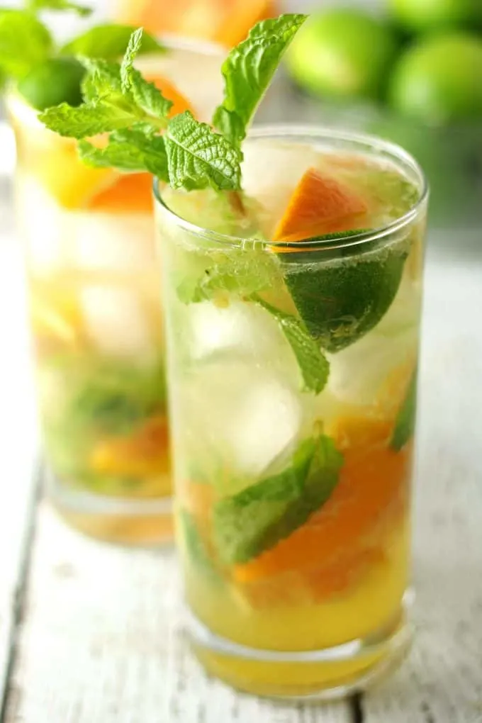 two orange mojitos in clear glasses