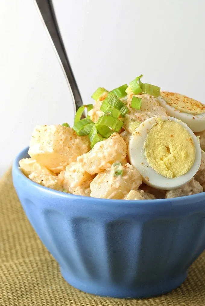 potato egg salad in a blue bowl