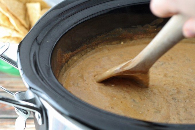 This slow cooker taco dip is perfect for parties - it can easily be thrown together in 2 hours with store bought ingredients! | honeyandbirch.com