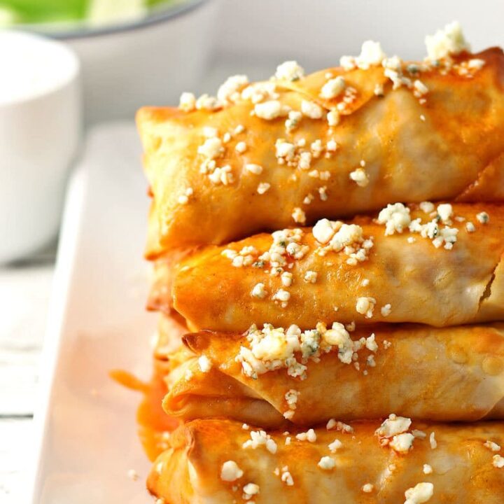 These baked buffalo chicken egg rolls are great as an appetizer or lunch! Pair them with blue cheese dressing and extra buffalo sauce! If you're looking for game day recipes, this is the perfect appetizer! | honeyandbirch.com