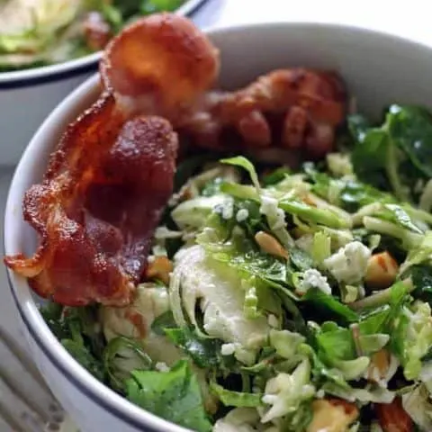 Brussels sprouts kale salad with bacon, almonds, blue cheese and a lemon garlic vinaigrette. Lunch is served! | honeyandbirch.com