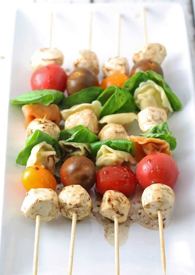 Caprese Tortellini Skewers are a fun appetizer on a stick! Perfect for parties and barbecues. | honeyandbirch.com