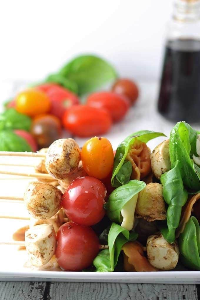 Caprese Tortellini Skewers are a fun appetizer on a stick! Perfect for parties and barbecues. | honeyandbirch.com