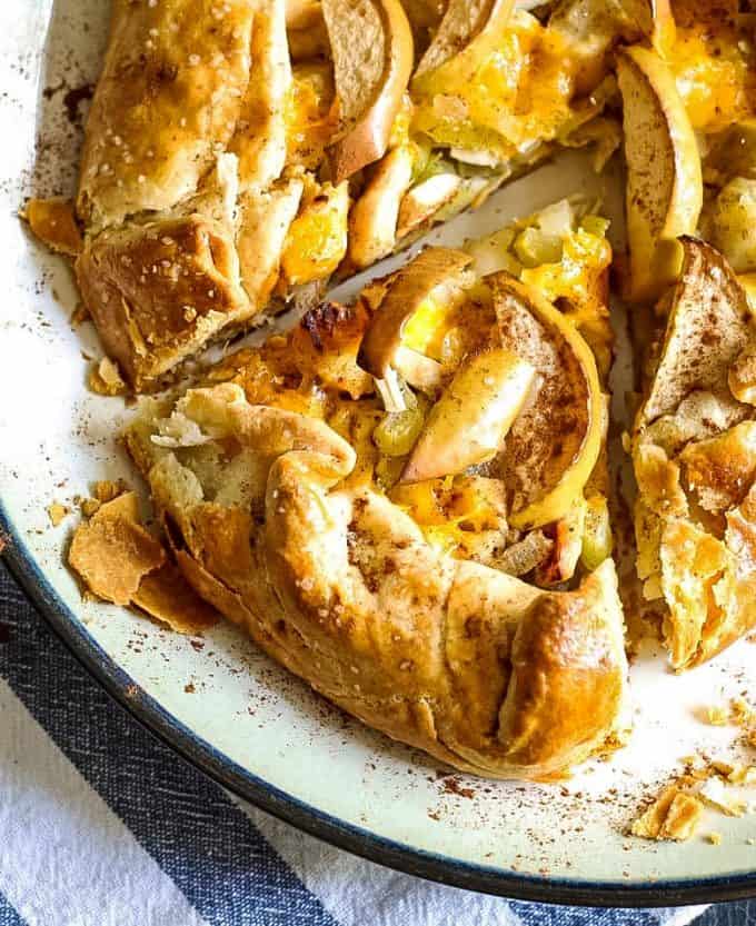 whole savory apple galette with a piece of apple galette