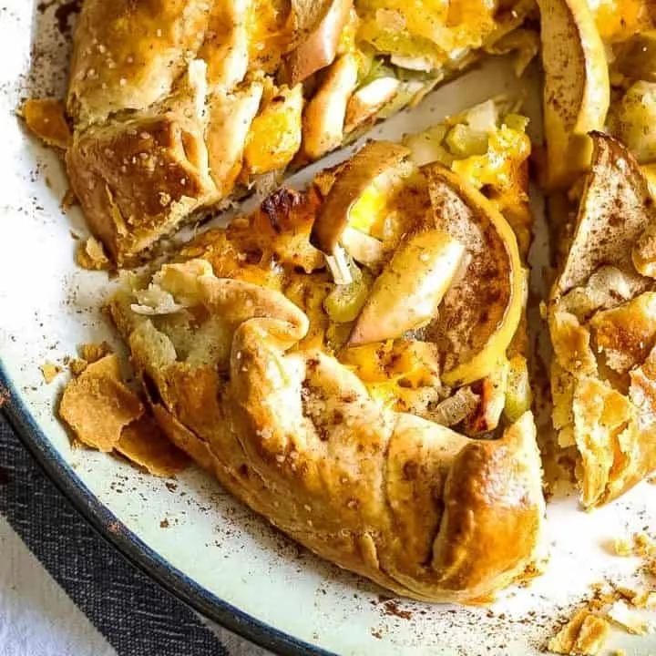 whole savory apple galette with a piece of apple galette