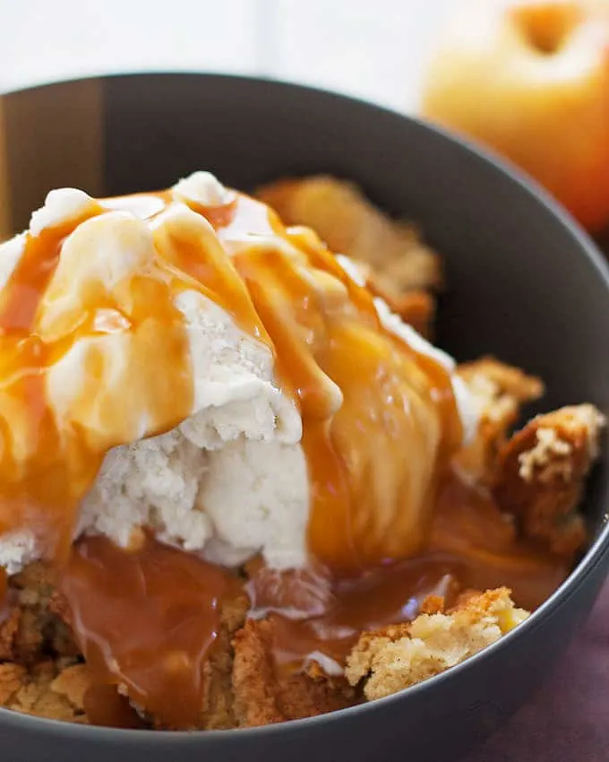 This apple cake sundae is a fun and easy fall dessert. Hot apple cake is topped with creamy vanilla ice cream and drizzles of caramel!