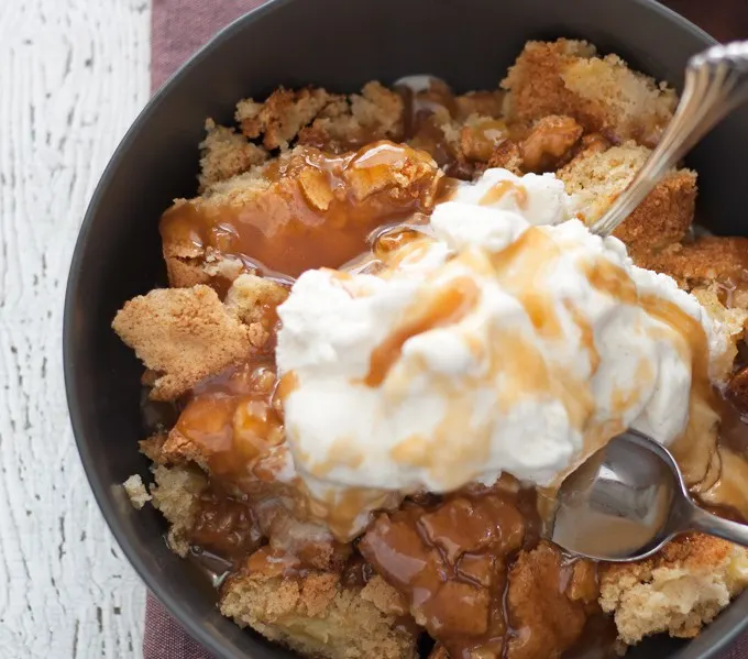 This apple cake sundae is a fun and easy fall dessert. Hot apple cake is topped with creamy vanilla ice cream and drizzles of caramel!