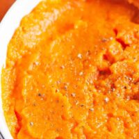 ginger mashed carrot side dish in a white bowl