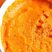 ginger mashed carrot side dish in a white bowl