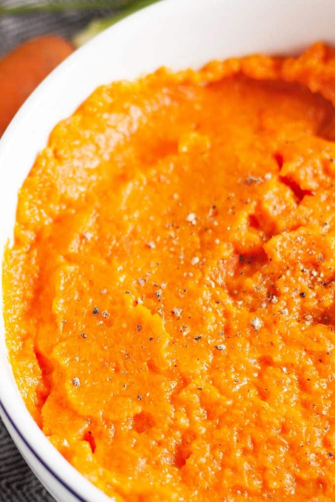 ginger mashed carrot side dish in a white bowl