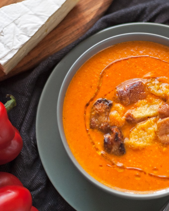 This roasted red pepper brie soup is creamy and smooth. Serve it with homemade croutons or crusty bread and a salad for the perfect cool-weather lunch! | honeyandbirch.com