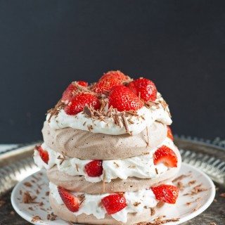 Chocolate Pavlova Cake - delicious chocolate meringue layered with whipped cream and fresh strawberries. | honeyandbirch.com
