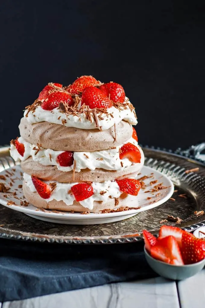 chocolate pavlova cake with strawberries and whipped cream