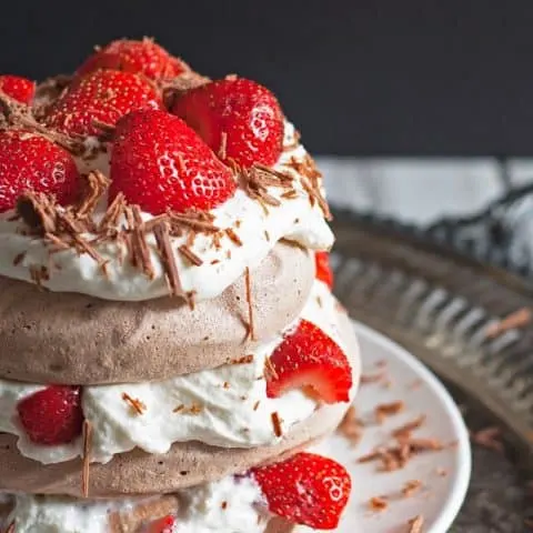 Chocolate Pavlova Cake - delicious chocolate meringue layered with whipped cream and fresh strawberries. | honeyandbirch.com