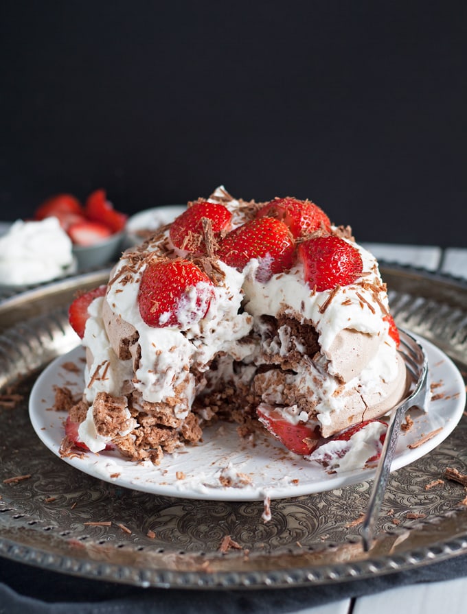 Chocolate Pavlova Cake - delicious chocolate meringue layered with whipped cream and fresh strawberries. | honeyandbirch.com